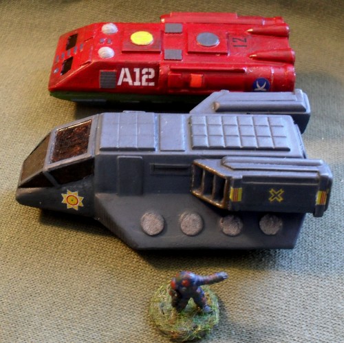 Foreground: Combat Wombat Assault Lander Background: Daemonscape Buffalo Transport